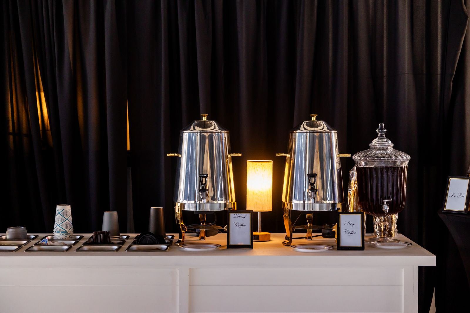 Styled coffee catering station with dispensers and cups