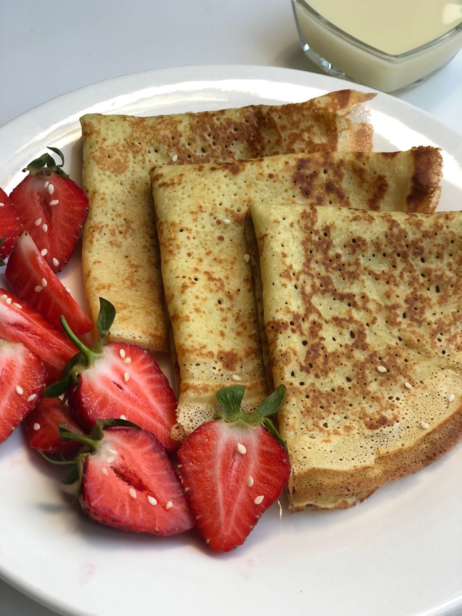 Golden crepes with fresh strawberries