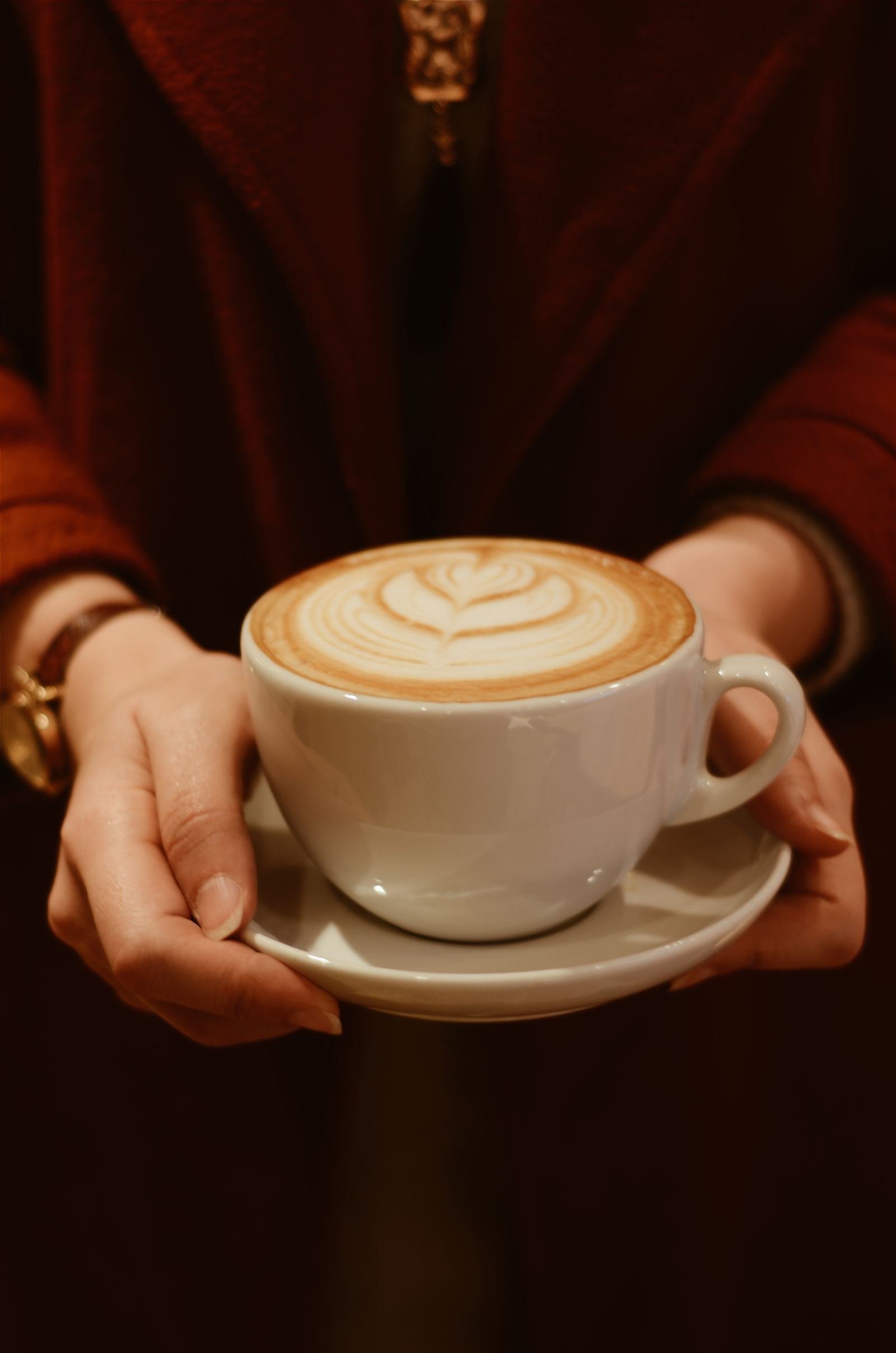 Warm latte with latte art in a cozy setting
