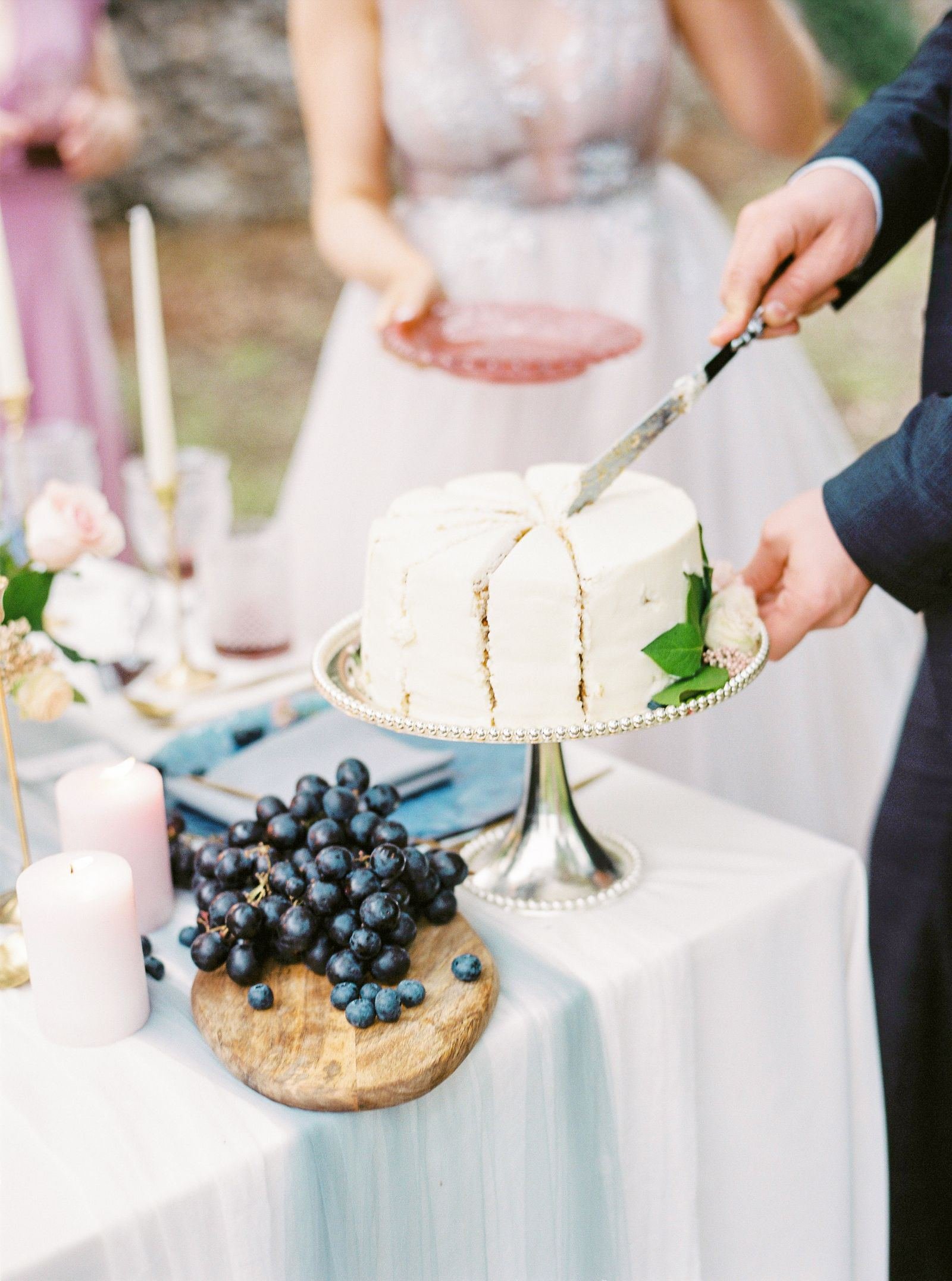 Bride and groom cutting their cake at an outdoor wedding